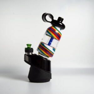 WIIDZ® Flask puffco peak pro glass attachment installed on puffco peak, facing east. The glass shaped like a flask with a blue air inlet tube inside the bottle. red, yellow, green, blue and white stripe swirl color on the top and bottom.