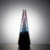 WIIDZ® Indiglow puffco peak pro glass attachment installed on puffco peak, facing south and lit from behind. The glass shaped like the original puffco peak pro glass but with diamond cut surface and iridescent color of purple and blue, just like the Puffco Peak Indiglow Glass.