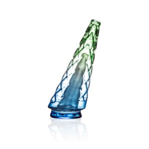 WIIDZ® Indiglow Hawaii light puffco peak pro glass attachment, facing west. The glass shaped like the original puffco peak pro glass but with diamond cut surface and iridescent color of blue and green.
