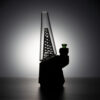 WIIDZ® Green twist puffco peak pro glass attachment installed on puffco peak, facing west lighted from behind. The glass shaped like OG peak glass, featuring the swirled green-white stripe on the inner chamber.