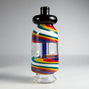 A Puffco Peak Pro glass attachment and Wiidz flask positioned facing south, showcasing their sleek designs and unique features.