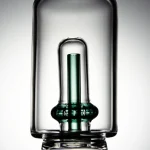 puffco peak pro glass attachment wiidz tipsy green inner tube close up shot.webp Close-up shot of Puffco Peak Pro glass attachment featuring Wiidz Tipsy green inner tube, highlighting its unique design and color for enhanced vaping experience.